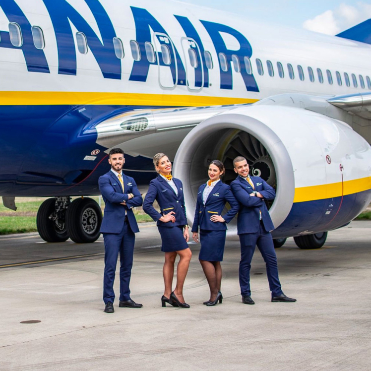 Ryanair staff posing outside a plane