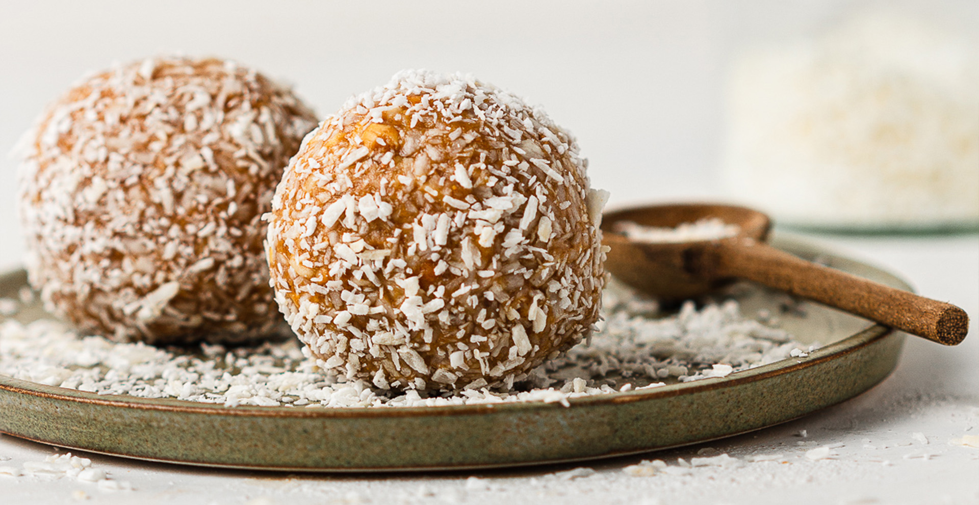 nut balls on plate with coconut powder